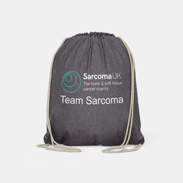 Charcoal grey drawstring bag with Sarcoma UK logo on