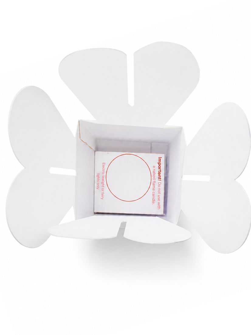 Flatpack white cardboard lantern with flower shape cutout top showing LED candle packaging