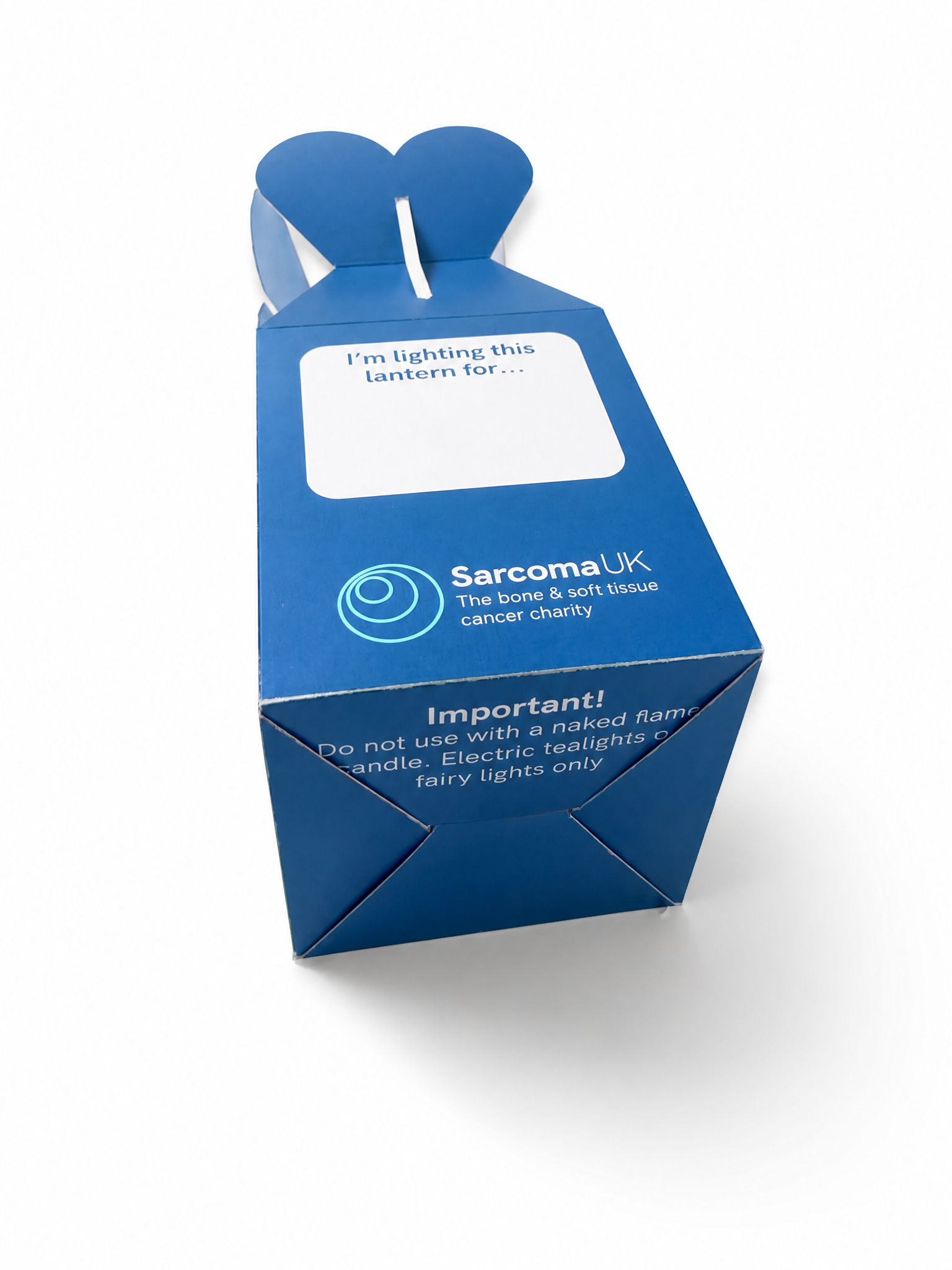 Flatpack white cardboard lantern with flower shape cutout top showing LED candle packaging
